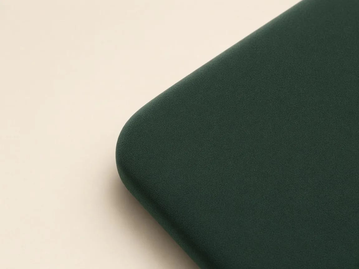 Soft-touch velvet coating on a forest green packaging panel